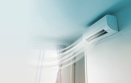 Split unit air conditioner blowing cool air into a room after being reinstalled