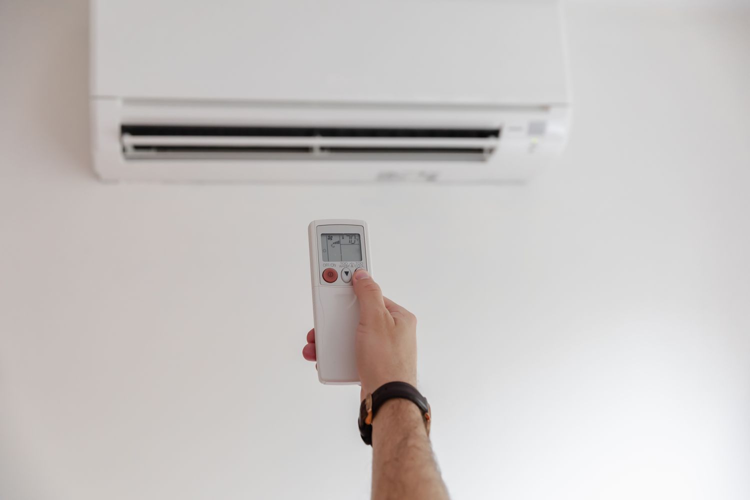 Wall-mounted air conditioner being operated with a remote in a commercial space